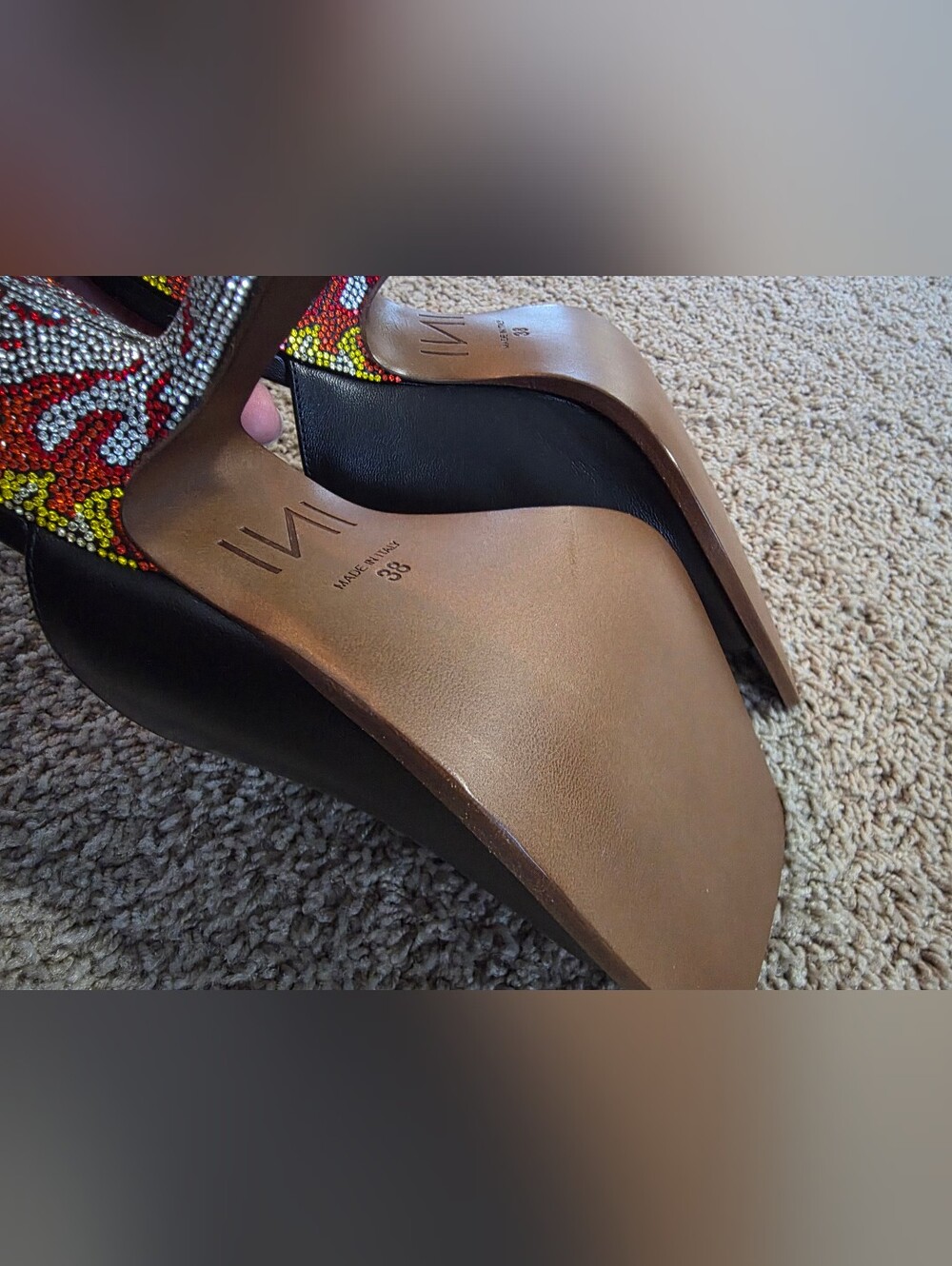 IINDACO leather mules featuring a bold crystal-embellished flame heel.